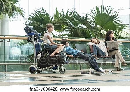 Stock Photo - Family waiting in airport terminal. Fotosearch