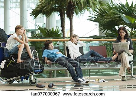 Stock Photo - Family waiting in airport terminal. Fotosearch