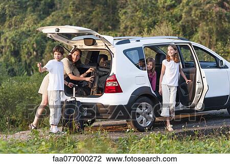 Stock Image - Family with SUV exploring the outdoors. Fotosearch