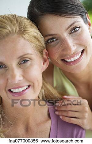 Female friends cheek to cheek, portrait View Large Photo Image Stock Photograph - Female friends cheek to cheek, portrait. Fotosearch