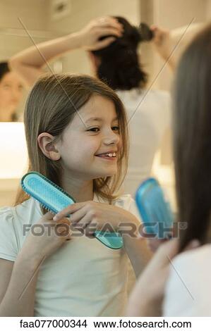 Picture - Girl brushing hair. Fotosearch