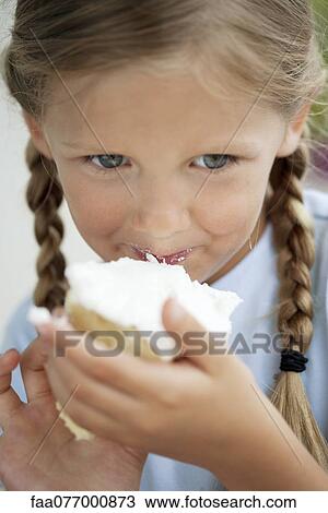 Girl eating cake View Large Photo Image Stock Image - Girl eating cake. Fotosearch