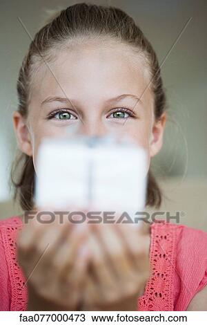 Stock Image - Girl holding out gift. Fotosearch
