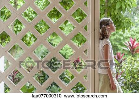 Stock Image - Girl listening to music outdoors with earphones. Fotosearch