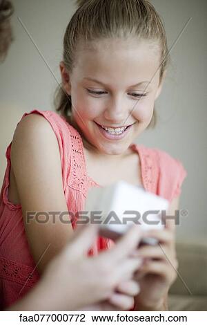 Girl opening gift View Large Photo Image Stock Image - Girl opening gift. Fotosearch