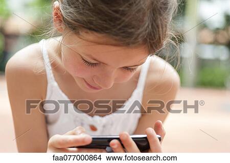 Girl playing video game View Large Photo Image Picture - Girl playing video game. Fotosearch