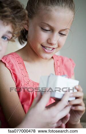 Girl receiving gift, cropped View Large Photo Image Stock Photo - Girl receiving gift, cropped. Fotosearch