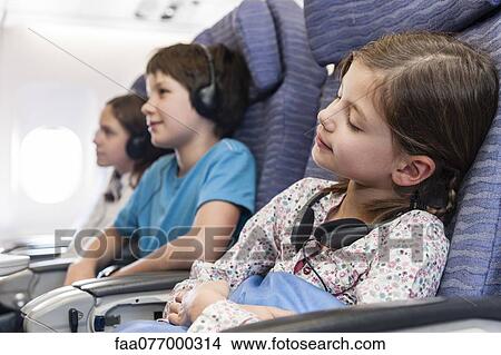 Picture - Girl sleeping on airplane. Fotosearch