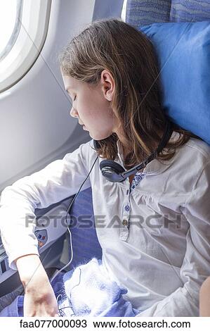 Girl sleeping on airplane View Large Photo Image Stock Image - Girl sleeping on airplane. Fotosearch