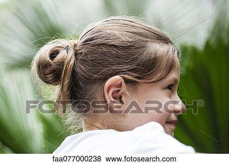 Girl with chignon, portrait View Large Photo Image Stock Photo - Girl with chignon, portrait. Fotosearch
