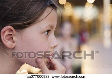 Stock Photo - Girl with finger in mouth. Fotosearch