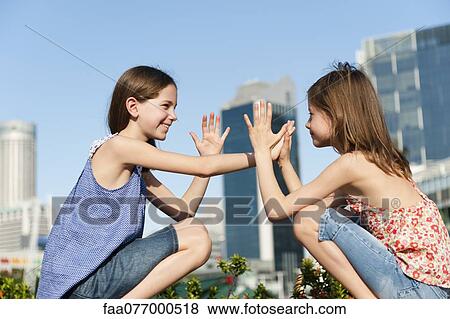 Stock Photo - Girls playing pattycake. Fotosearch