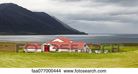 Iceland, barn on coastal farmland with mountains in background View Large Photo Image Picture - Iceland, barn on coastal farmland with mountains in background. Fotosearch