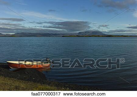 Iceland, boat resting on lake shore View Large Photo Image Stock Photo - Iceland, boat resting on lake shore. Fotosearch