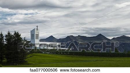 Stock Photograph - Iceland, church with mountains in background. Fotosearch