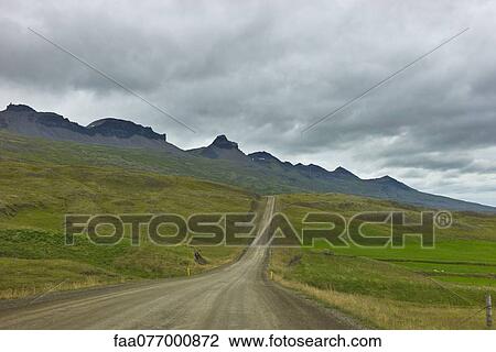 Stock Image - Iceland, dirt road through countryside. Fotosearch
