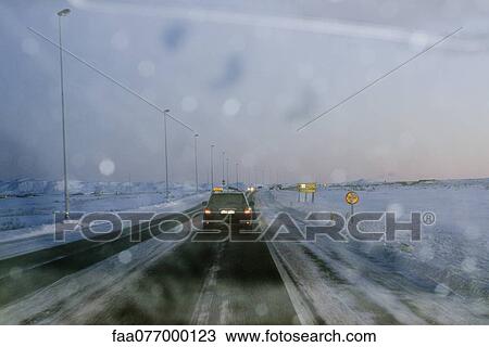 Stock Image - Iceland, road from Keflavik airport to Reykjavik viewed through windshield. Fotosearch