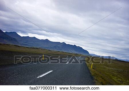 Stock Image - Iceland, road through countryside. Fotosearch