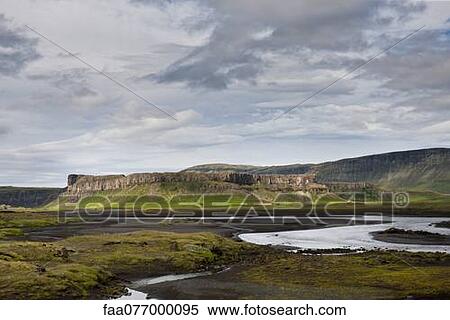 Iceland, stream running through lava field, basalt cliffs in the distance View Large Photo Image Stock Photography - Iceland, stream running through lava field, basalt cliffs in the distance. Fotosearch