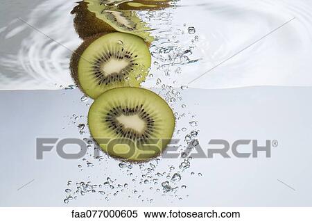 Kiwi halves submerged in water View Large Photo Image Stock Photography - Kiwi halves submerged in water. Fotosearch