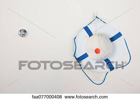Stock Photo - Life preserver hanging on wall. Fotosearch