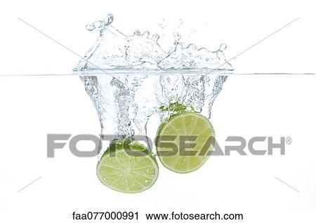 Lime halves splashing into water View Large Photo Image Stock Image - Lime halves splashing into water. Fotosearch