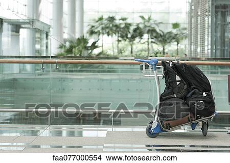 Picture - Luggage cart with luggage in airport. Fotosearch