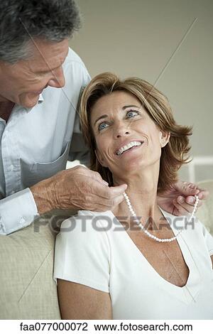 Mature man giving woman a pearl necklace View Large Photo Image Stock Image - Mature man giving woman a pearl necklace. Fotosearch