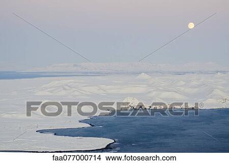 Picture - Moon rising over coast of Iceland. Fotosearch