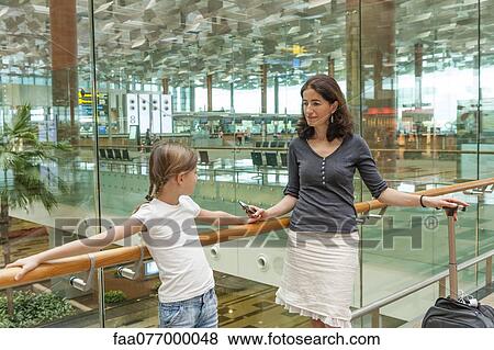 Mother and daughter in airport View Large Photo Image Stock Photo - Mother and daughter in airport. Fotosearch