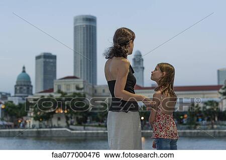 Stock Photograph - Mother and daughter looking at view. Fotosearch