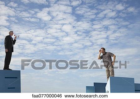 Oversized men standing on rooftops, one speaking through megaphone View Large Photo Image Stock Photograph - Oversized men standing on rooftops, one speaking through megaphone. Fotosearch