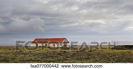 Stock Image - Panoramic rural scene with barn, Iceland. Fotosearch