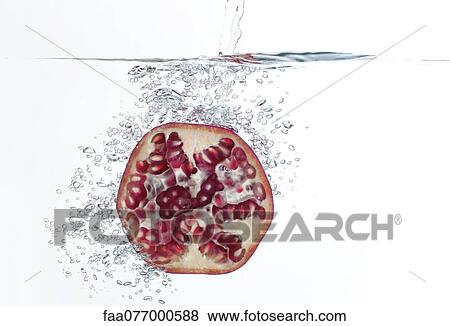 Stock Photo - Pomegranate half submerged in water. Fotosearch