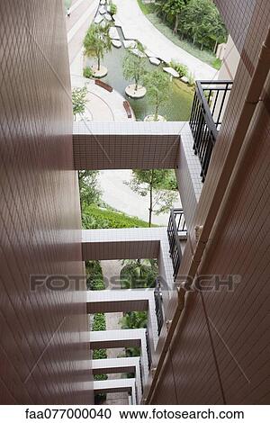 Stock Image - Repeating balconies on high rise building, cropped. Fotosearch