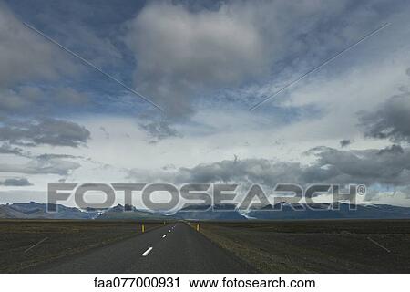 Stock Image - Road through barren landscape, Iceland. Fotosearch