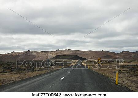 Stock Image - Road winding through barren landscape, Iceland. Fotosearch