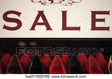 Stock Photo - Sale sign over shoe rack. Fotosearch