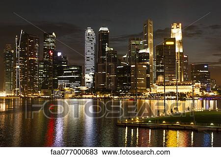 Stock Image - Singapore waterfront skyline at night viewed from esplanade. Fotosearch
