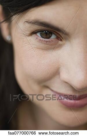 Stock Photograph - Smiling mid-adult woman, cropped portrait. Fotosearch