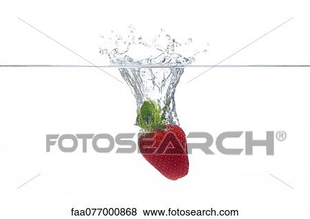 Stock Photo - Strawberry splashing into water. Fotosearch