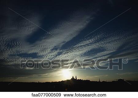 Stock Photo - Sun setting over Paris, France. Fotosearch