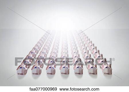 Stock Photo - Ten Euro banknotes folded into the shapes of houses. Fotosearch