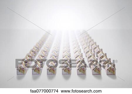 Picture - Ten pound notes folded into the shapes of houses. Fotosearch