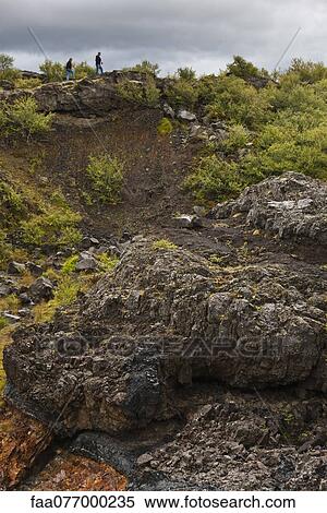 Tourists walking along hillside of lava field, Iceland View Large Photo Image Stock Photography - Tourists walking along hillside of lava field, Iceland. Fotosearch