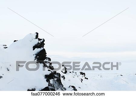 Stock Photograph - Volcanic rock covered in snow, Reykjanes Peninsula, Iceland. Fotosearch