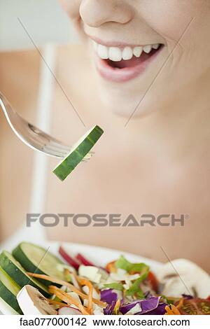 Woman eating salad, cropped View Large Photo Image Stock Image - Woman eating salad, cropped. Fotosearch