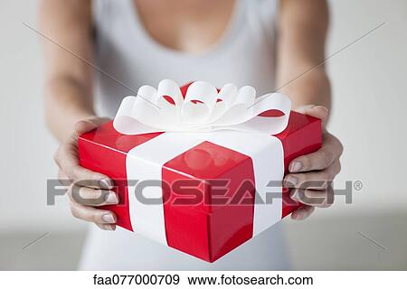 Woman holding gift box, cropped View Large Photo Image Stock Photo - Woman holding gift box, cropped. Fotosearch