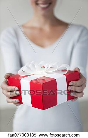 Woman holding gift box, cropped View Large Photo Image Stock Photography - Woman holding gift box, cropped. Fotosearch