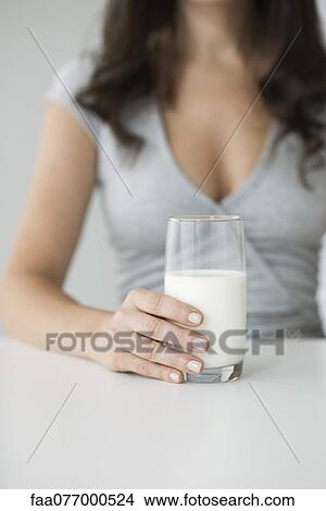 Woman holding glass of milk View Large Photo Image Picture - Woman holding glass of milk. Fotosearch